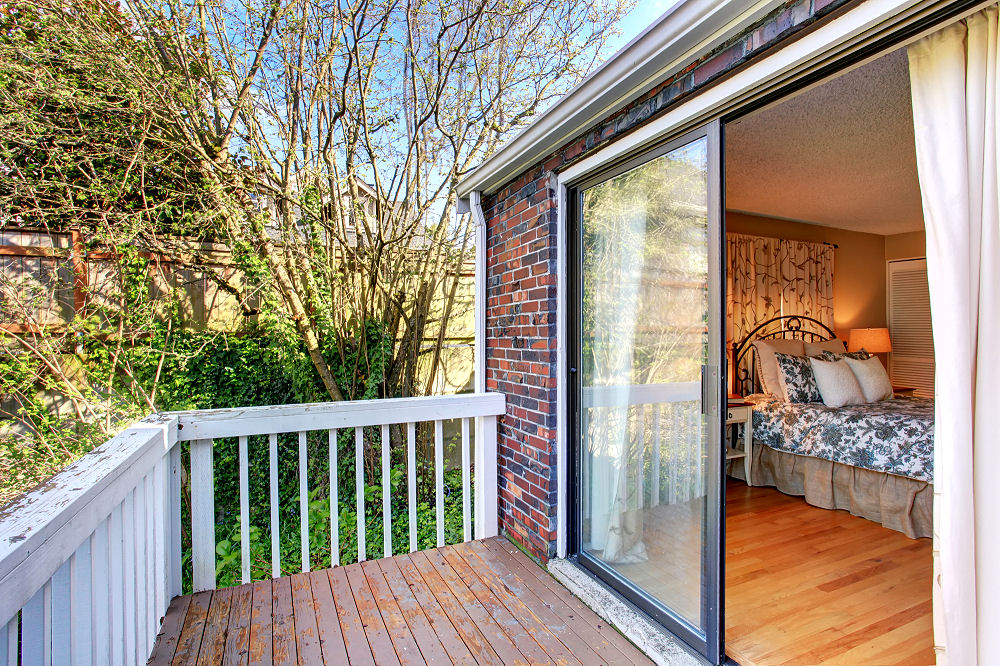 Schiebetür aus Glas vom Schlafzimmer auf eine kleine Terrasse