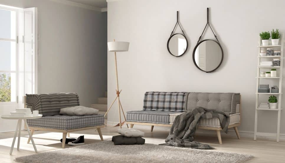 Skandinavisches Wohnzimmer mit Couch, Sessel und weichem Fellteppich